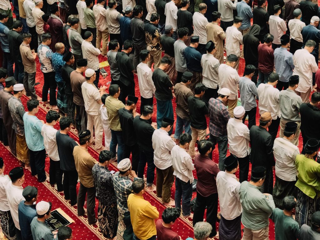 Muslims gathered inside a mosque for prayer, showing unity and devotion in Islamic practice.