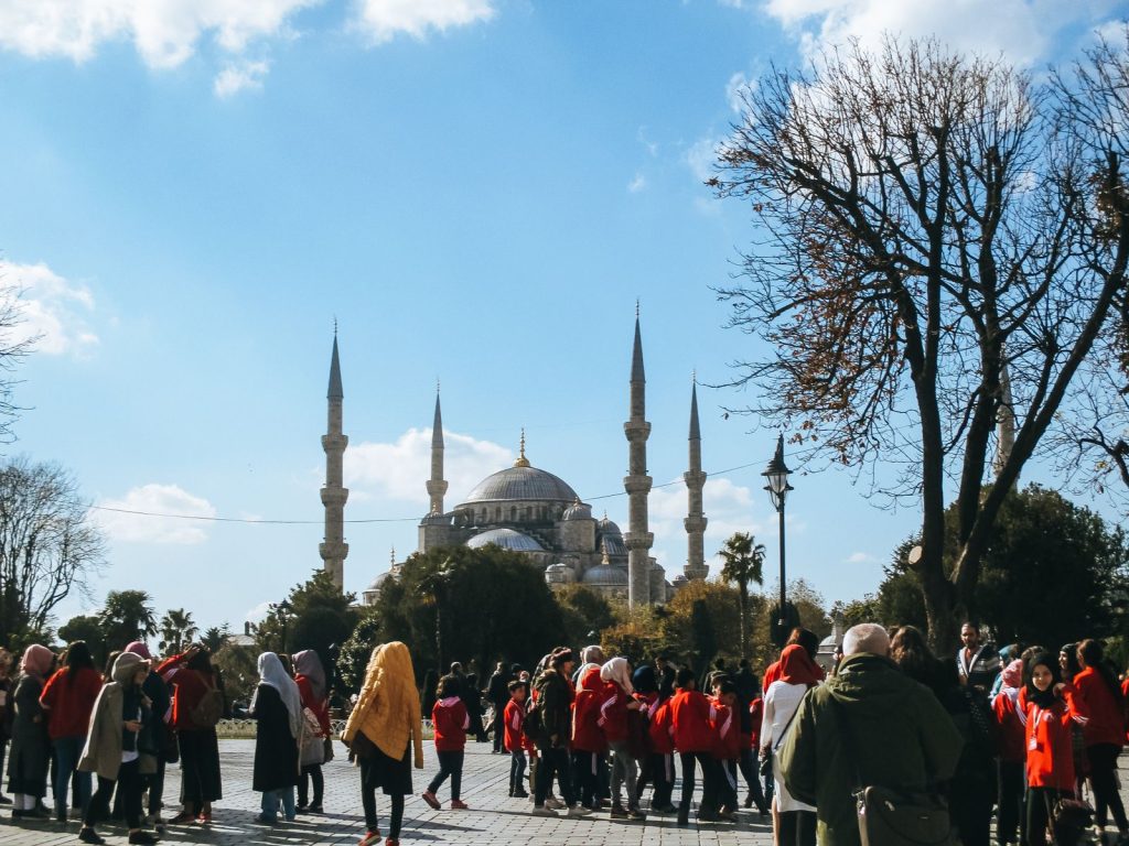 Visitors gather near the iconic Blue Mosque in Istanbul, a symbol of Turkish architecture.